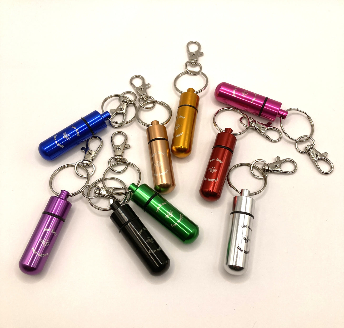 Image showing the eight different keyrings available in the bee revival kit - red, silver, gold, blue, purple, black, green, rose gold and pink