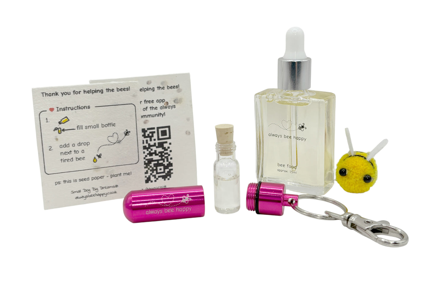 Bee revival kit including a 15ml bottle for top-ups, pink aluminium keychain with inner glass vial and premium cork, and instruction card on seed paper. And a fluffy bee of course.