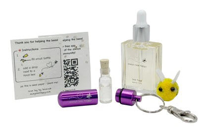 Bee revival kit including a 15ml bottle for top-ups, purple aluminium keychain with inner glass vial and premium cork, and instruction card on seed paper. And a fluffy bee of course.