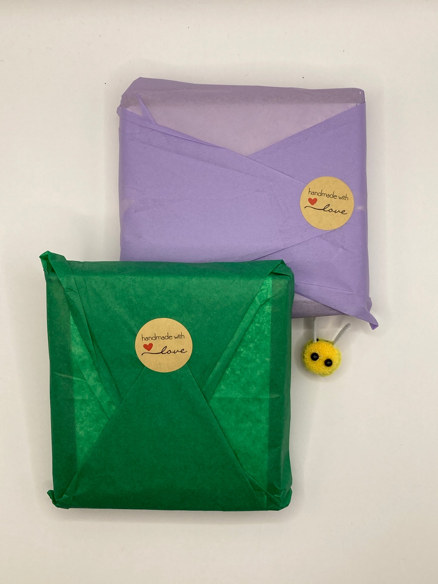 Every revival kit is gift wrapped. This image shows two bee revival kits gift wrapped in two of the  many colours we use - lilac and green.There&#39;s a cute fabric bee next to the revival kits